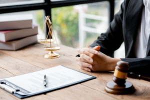 A woman lawyer sits in the office of her law firm.