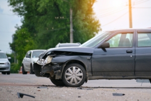 Damaged in car accident vehicle on city street crash site