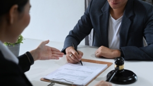 Shot of lawyer or attorney explaining terms, condition on legal document.