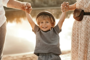 Parents holding hands of smiling child