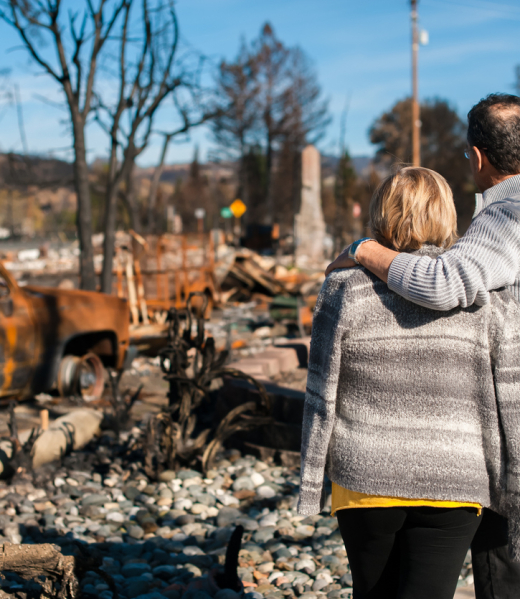 Man and his wife owners, checking burned and ruined house and yard after fire, consequences of fire disaster accident. Ruins after fire disaster.